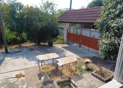 Outdoor patio area with garden and tiled tables