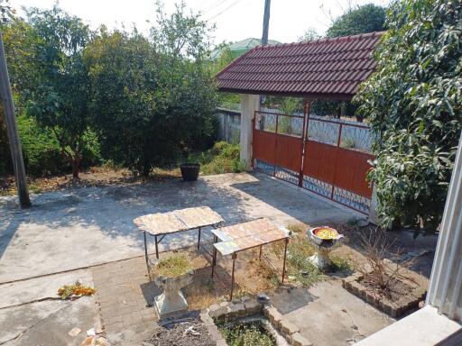 Outdoor patio area with garden and tiled tables