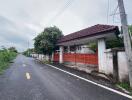 Gated Entrance of a House with Red Fence