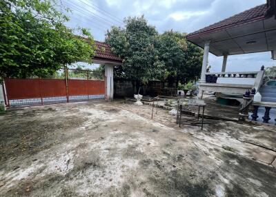 Spacious outdoor area with seating and plenty of greenery