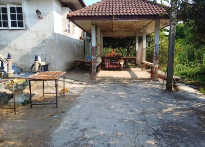 Covered outdoor seating area beside the house