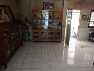 Living room with tile flooring and glass-front cabinets