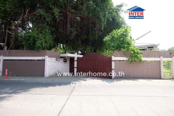 Front view of the property with gate and surrounding wall