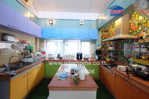 Modern kitchen with colorful cabinets and mosaic backsplash