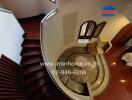 Aerial view of a living room with hardwood floors and a staircase