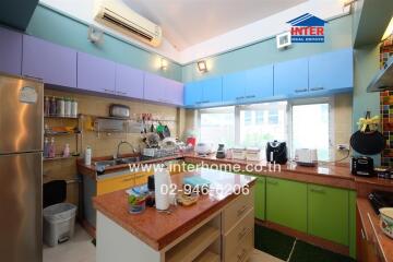 Modern kitchen with colorful cabinets and appliances