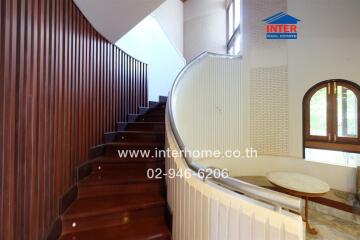Modern staircase with wooden steps and white banister
