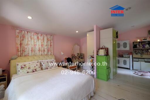 Cozy bedroom with pink walls and floral decorations