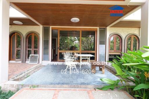 Exterior view of a house with a patio and garden