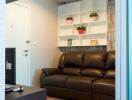 Cozy living room with a brown leather sofa and shelving