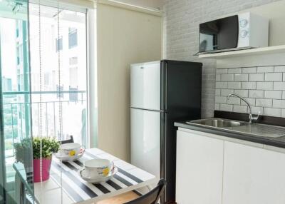 Modern kitchen with dining area and balcony view