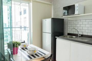 Modern kitchen with dining area and balcony view