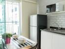 Modern kitchen with dining area and balcony view