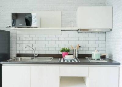 Modern kitchen with white cabinets, countertop, and appliances