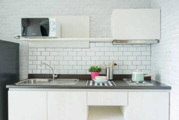 Modern kitchen with white cabinets, countertop, and appliances