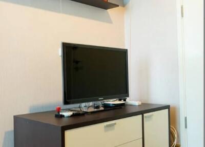 Modern living room with entertainment unit and wall shelf