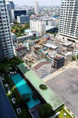 View from high-rise building showing cityscape and swimming pool