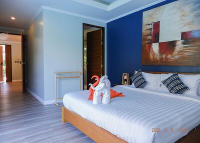 Modern bedroom with blue accent wall, double bed, and decor