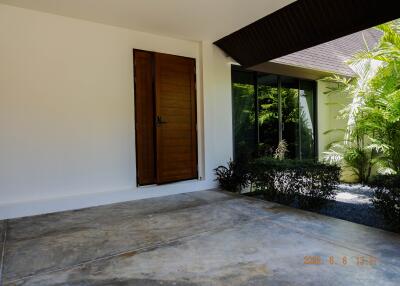 Front entrance area with door and garden view