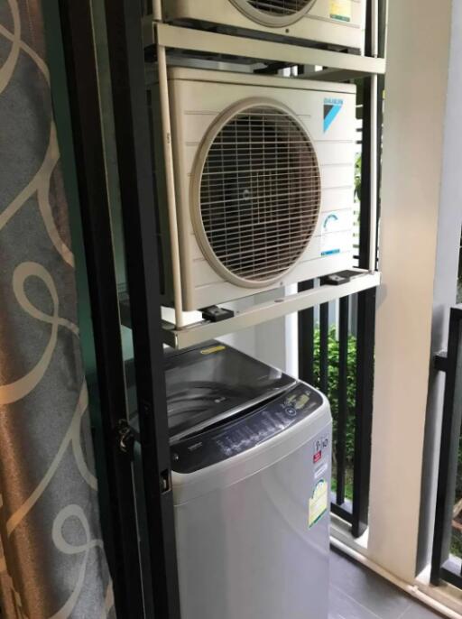 Laundry area with washing machine and air conditioner unit