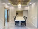 Elegant dining area with cushioned chairs, chandelier, and built-in cabinetry