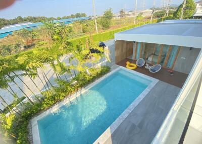 Swimming pool with patio and greenery