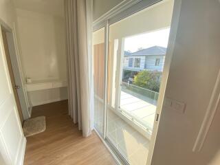 Bedroom with large sliding glass door leading to balcony