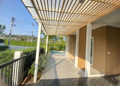 Modern patio with wooden slat pergola and tiled floor
