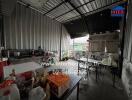 A spacious and functional industrial-style kitchen with various appliances and dining area.