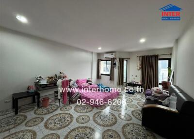 Spacious living room with tiled floor and furnishings.