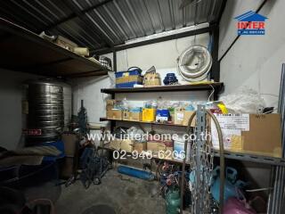 A cluttered storage room with various items and shelves.