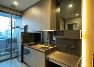 Modern kitchen with built-in appliances and a view of the city