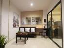 Modern living room with a brown sofa, coffee table, and glass partition