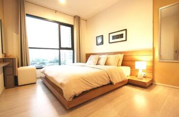 Spacious and well-lit bedroom with double bed and modern decor