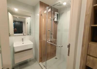 Modern bathroom with glass shower and white sink