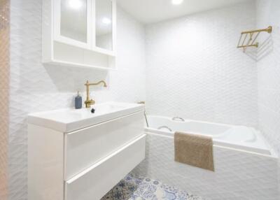 Modern bathroom with white vanity and bathtub