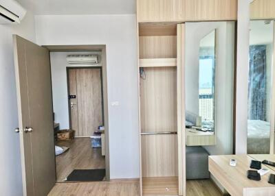 Bedroom with wooden wardrobe and door to other room