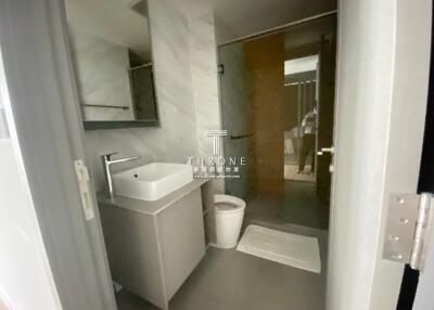 Modern bathroom with vanity, washbasin, and shower area