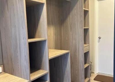 Spacious walk-in closet with wooden shelving