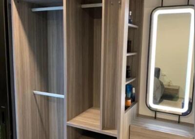 Bedroom closet with built-in shelves and mirror