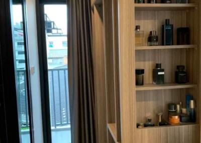 Modern walk-in closet with shelving and perfume bottles