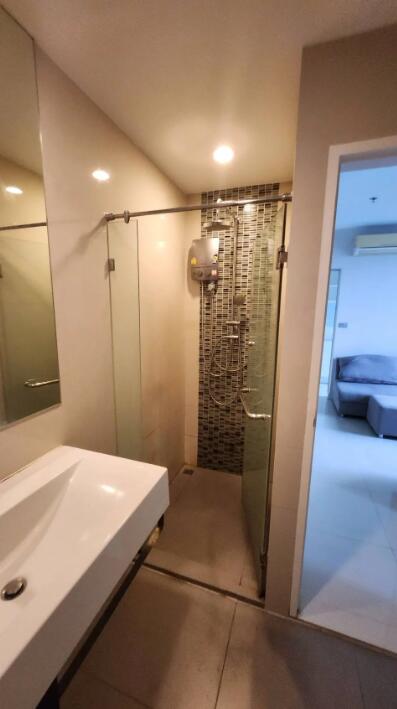 Modern bathroom with glass shower enclosure and large mirror