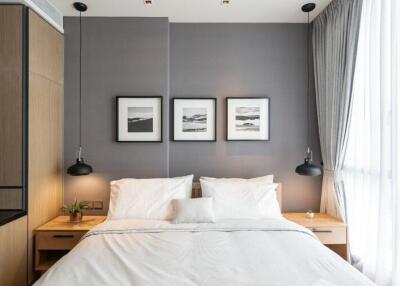 Modern bedroom with gray accent wall and decorative lighting