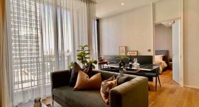 Modern living room with large windows and a view of the city