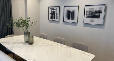 Modern dining room with a marble table and contemporary artwork