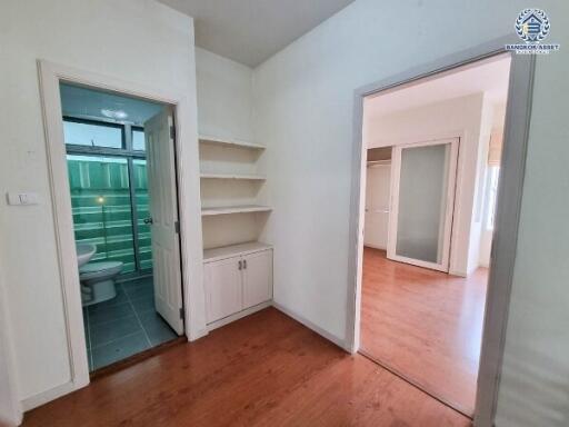 View of interior space with hallway, bathroom, and another room