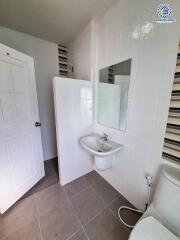 Modern bathroom with sink, toilet, and partially visible shower area