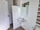 Modern bathroom with sink, toilet, and partially visible shower area