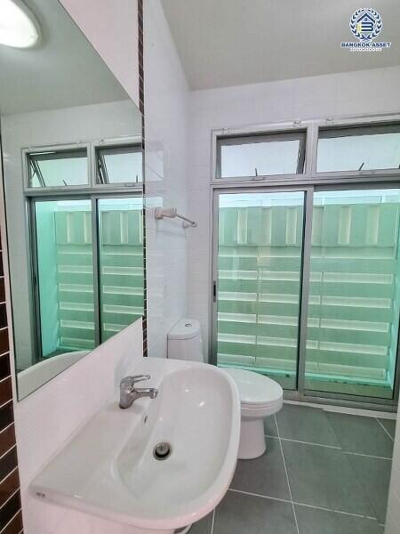 Modern bathroom with sink, toilet, and large window