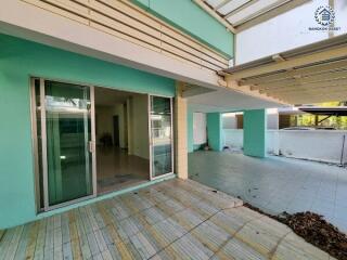 Covered outdoor patio area with sliding glass doors